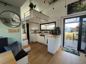 a kitchen and living room of a tiny house at Tiny House Spreemaus in Hangelsberg