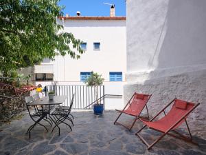 a patio with two chairs and a table and a table at Apartment at Cadaqués Church in Cadaqués