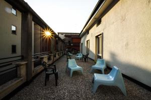 a group of chairs sitting on the side of a building at Green Bed Bergamo Guest House & Residence in Bergamo