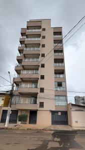 a tall apartment building with windows at Studio Moderno e Aconchegante , Centro Unai in Unaí