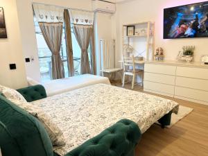 a bedroom with a bed and a tv on the wall at Summer Studio in Constanţa