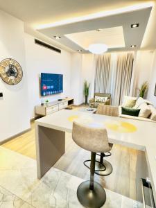 a living room with a table and a couch at Elite Luxury Suites at The Diamond in City in Cantonments