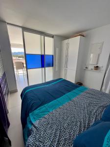a bedroom with a bed and a large window at TOUT A PIED Dernier étage Vue imprenable EST-SUD OUEST mer -plage 100m-box in Six-Fours-les-Plages