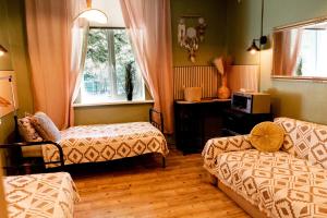 a room with a bed and a couch and a window at Kempings Liepene in Liepene +174 photos