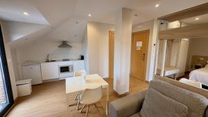 a living room with a couch and a table at Apartamentos La Canal in Soto de la Marina