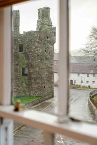 a view of a castle from a window at Mackenzie House in Kirkcudbright