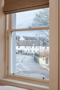 an open window with a view of a street at Mackenzie House in Kirkcudbright +33 photos
