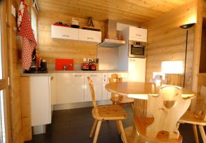 a kitchen with a table and chairs in a cabin at Apartment Anna in Courchevel