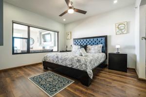 a bedroom with a bed and a ceiling fan at Mar y Sol 16th floor Condo in Rosarito