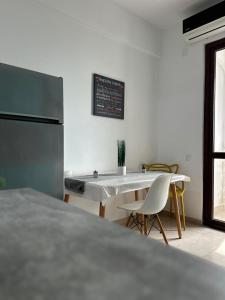 a kitchen with a table and chairs in a room at Travel Studio in Iaşi +1 photo