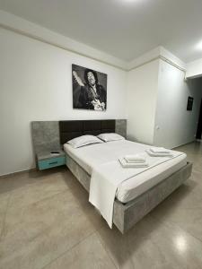 a bedroom with a bed and a picture on the wall at Travel Studio in Iaşi