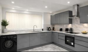 a kitchen with a sink and a dishwasher at Spacious 2 bedoom house in Wyken
