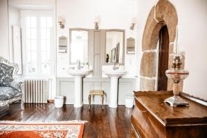 a bathroom with two sinks and a mirror at Manoir La Ville Durand in Binic +57 photos