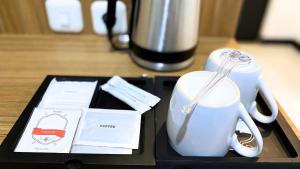 a table with a coffee mug and a blender at Koa Living Semarang in Kalibanteng-kidul