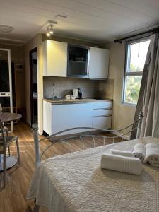 a bedroom with a bed and a kitchen with a sink at Residence Sa Pintadera in Càbras +30 photos