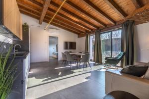 a kitchen and living room with a table and chairs at Suite Home Ferrara in Ferrara