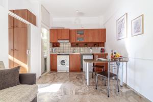 a small kitchen with a table and a stove at Irene Studio in Amoudara Herakliou