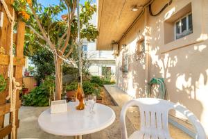 a white table and chairs on a patio at Irene Studio in Amoudara Herakliou