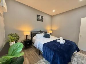 a bedroom with a bed with a blue blanket at Modern apartment close to NYC in North Bergen