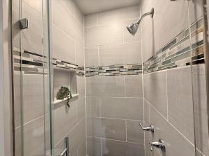 a bathroom with a shower with a glass door at Modern apartment close to NYC in North Bergen