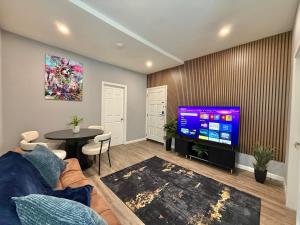 a living room with a couch and a tv at Modern apartment close to NYC in North Bergen