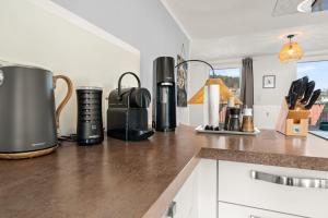 a kitchen counter with a coffee maker on it at Tucan - Rooftop Terrace with View, BBQ, PS4+Stream in Marburg an der Lahn +15 photos