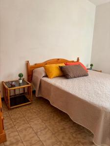 a bedroom with a bed with two pillows on it at Appartamenti Mare Blu in Isola Rossa