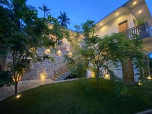 an exterior view of a house at night with lights at Villa Rosewood in Hiriketiya +41 photos