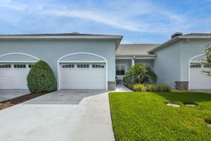 a house with two garage doors in a yard at Pool Access + Course View: Golf Getaway in Sebring in Sebring