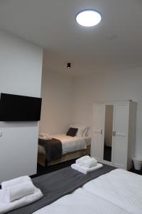 a hotel room with two beds and a mirror at nurHotel in Reinbek
