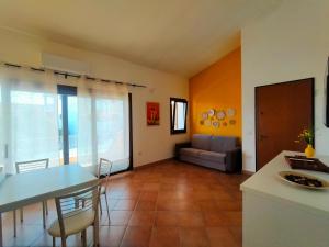 a kitchen and living room with a table and a couch at Seaside Home - Palau in Palau