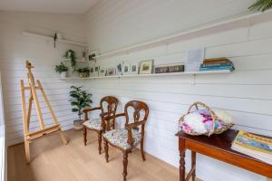 a room with two chairs and a table and a ladder at Nan's House in Mansfield