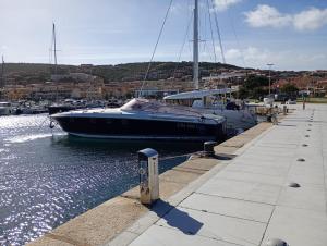 a boat is docked at a dock in the water at Seaside Home - Palau in Palau