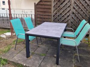 three chairs and a table and a table and chairs at Wolfskraft in Hauenstein