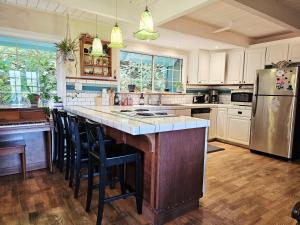 a kitchen with a large island with bar stools at Sky Cabin in Aptos