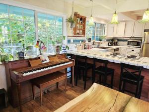 a kitchen with a piano in the middle of a kitchen at Sky Cabin in Aptos