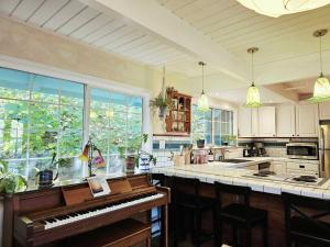 a kitchen with a piano in the middle of a kitchen at Sky Cabin in Aptos