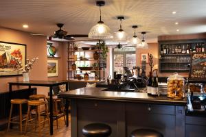 a bar in a restaurant with a counter and stools at The Mistley Thorn in Mistley