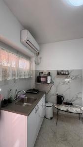 a small kitchen with a sink and a counter at Eilat Room in Eilat