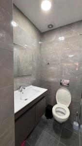 a bathroom with a white toilet and a sink at Eilat Room in Eilat