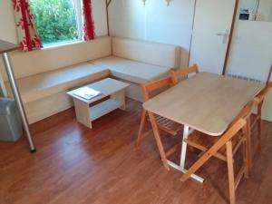a room with a table and a table and a bench at Camping 3 étoiles - ccbfgdc in Neuvic