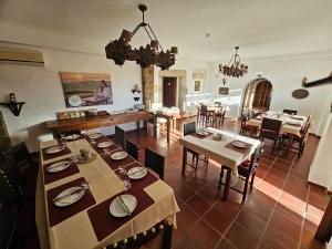 a dining room with tables and chairs in a room at Convento da Provença in Portalegre