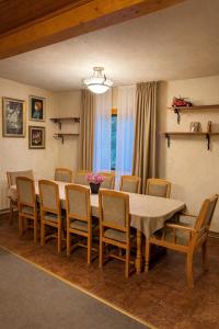 a dining room with a table and chairs at Cabana Brazilor in Câmpina