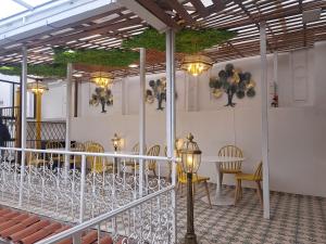 a room with chairs and a table and lights at Rossa Mia Hotel Boutique in Quito