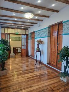 a hallway with wooden floors and blue and white walls at Rossa Mia Hotel Boutique in Quito +87 photos