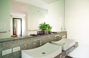 a bathroom with two sinks and a large mirror at Royal Shell by Utalay Koh Chang in Ban Khlong Son +70 photos
