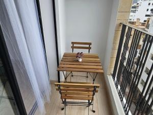a wooden table with a stuffed animal on top of a balcony at Appartement de standing - Emplacement stratégique in Casablanca