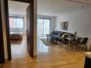 a living room with a couch and a table at Appartement de standing - Emplacement stratégique in Casablanca