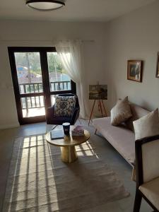a living room with a couch and a coffee table at Sunset View in Somerset West