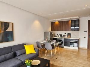 a living room with a couch and a table at Appartement de standing - Emplacement stratégique in Casablanca +10 photos